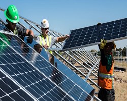Technicians installing solar panels