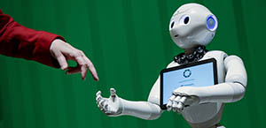 Person shaking hand with a robot