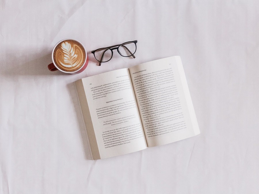 Book and glasses with coffee