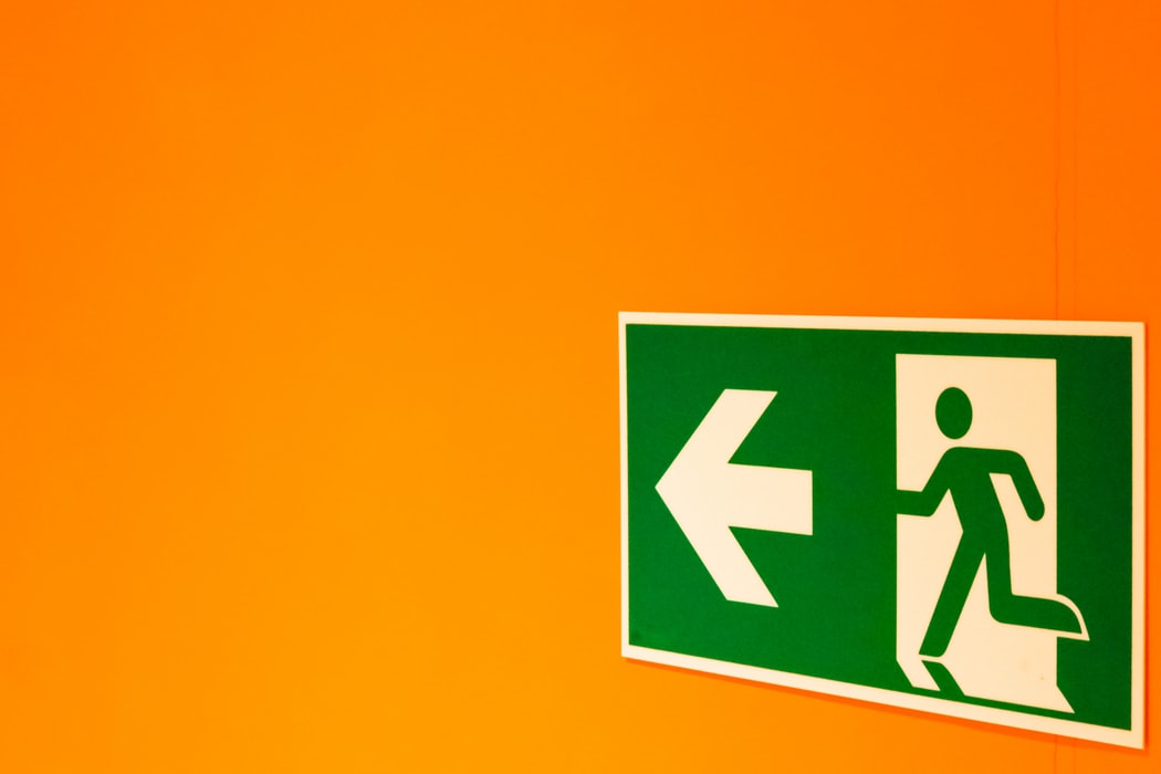 emergency exit sign on orange backgroun