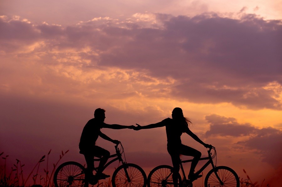 Cyclists Holding Hands