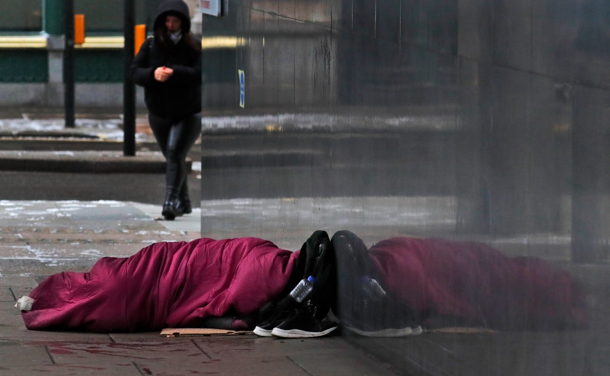 A person sleeps rough on the streets of London