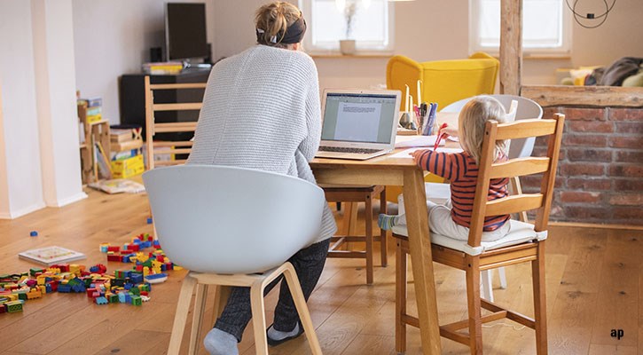 Mother working at home with child