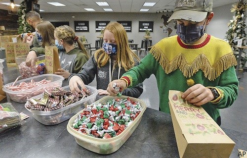 Kids packing Hershey's candy for Christmas