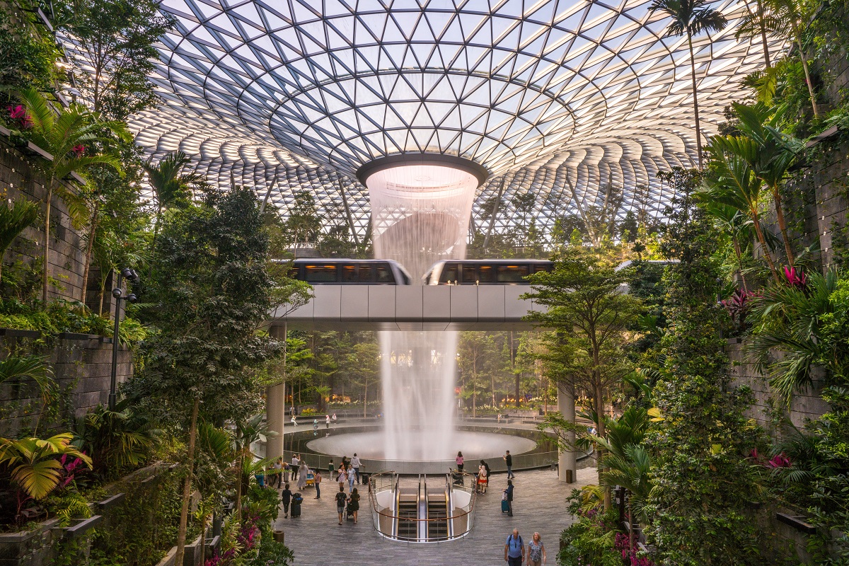 Water fountain in Singapore airport surrounded by greenery