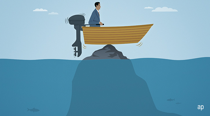 man in a boat stranded on a rock