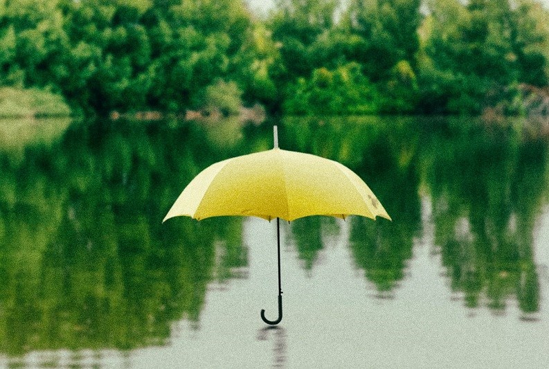 Yellow umbrella on lake