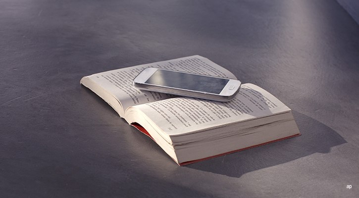 Smartphone laying on a book