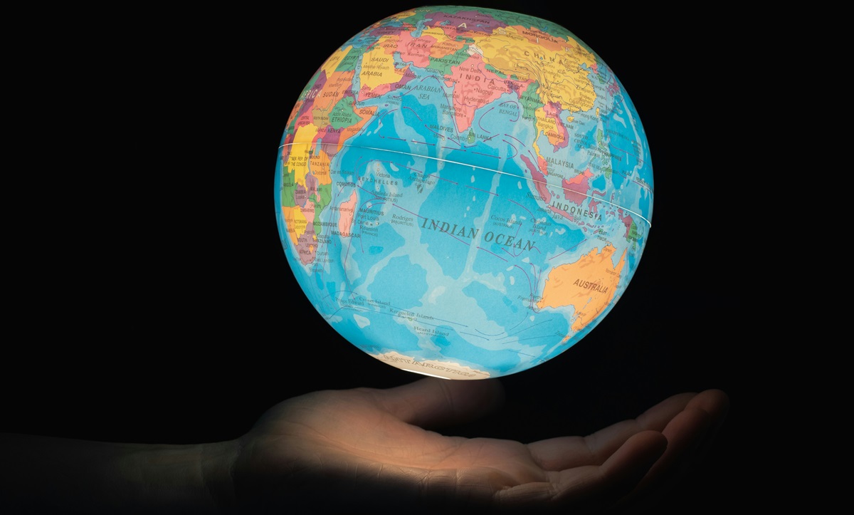 Person holding a glowing globe