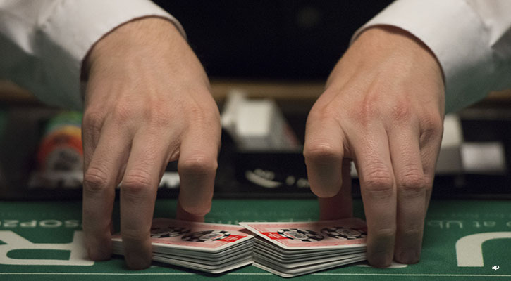 man shuffling deck of cards