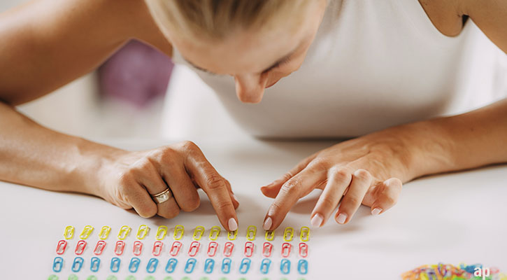Woman sorting paperclips